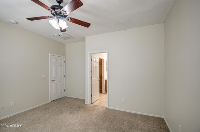 spare room featuring a healthy amount of sunlight, light carpet, and ceiling fan