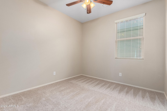 spare room featuring carpet floors and ceiling fan