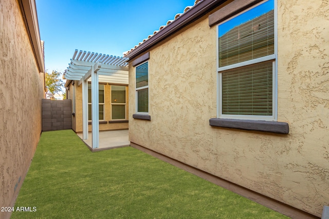 view of property exterior featuring a pergola and a patio