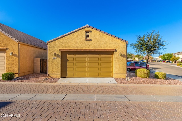 view of front of property featuring a garage and an outdoor structure