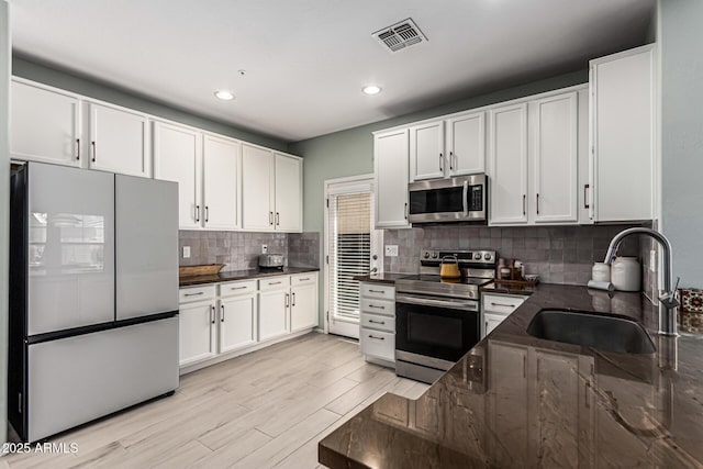 3037 E Hobart St, Gilbert, AZ 85296 - kitchen featuring appliances with stainless steel finishes, white cabinetry, decorative backsplash, light wood-style floors, and recessed lighting