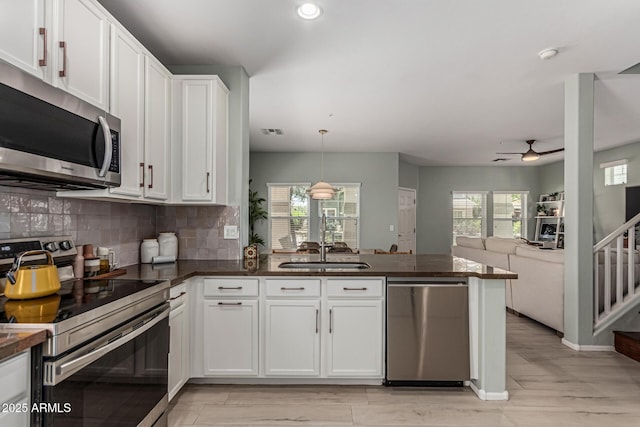 3037 E Hobart St, Gilbert, AZ 85296 - kitchen featuring appliances with stainless steel finishes, ceiling fan, dark countertops, a peninsula, and recessed lighting