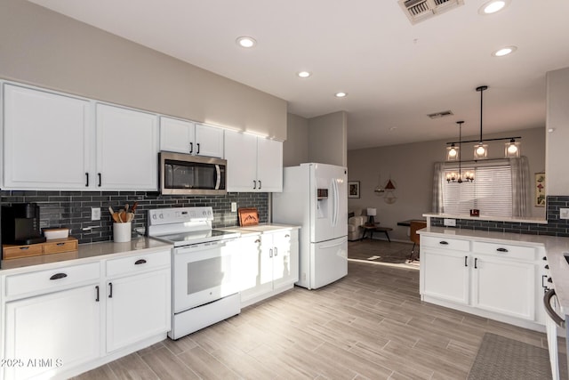 kitchen featuring decorative light fixtures, backsplash, white appliances, and white cabinetry