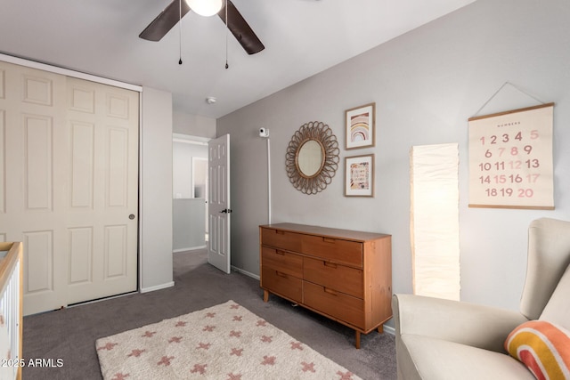 bedroom with ceiling fan, a closet, and dark colored carpet