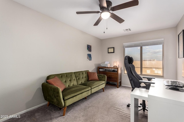 office space featuring light carpet and ceiling fan