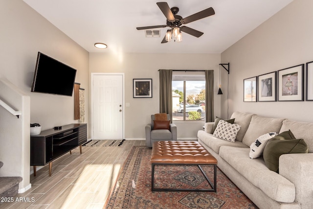 living room featuring ceiling fan and hardwood / wood-style floors