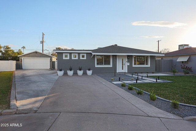 ranch-style home featuring a front yard, a garage, central AC unit, and an outdoor structure