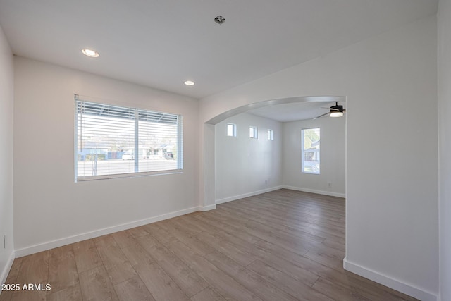 empty room featuring ceiling fan and light hardwood / wood-style floors