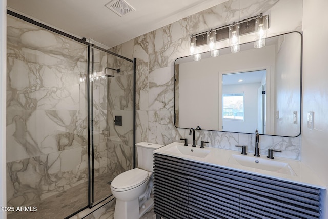 bathroom featuring vanity, toilet, walk in shower, and tile walls