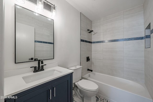 full bathroom featuring vanity, tiled shower / bath combo, and toilet