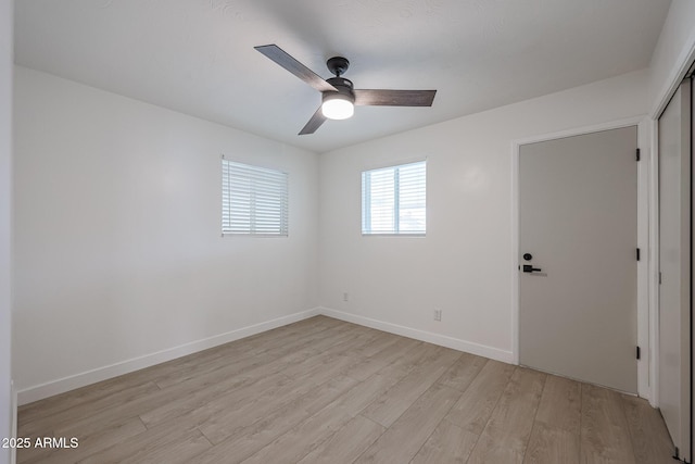 spare room featuring ceiling fan and light hardwood / wood-style flooring