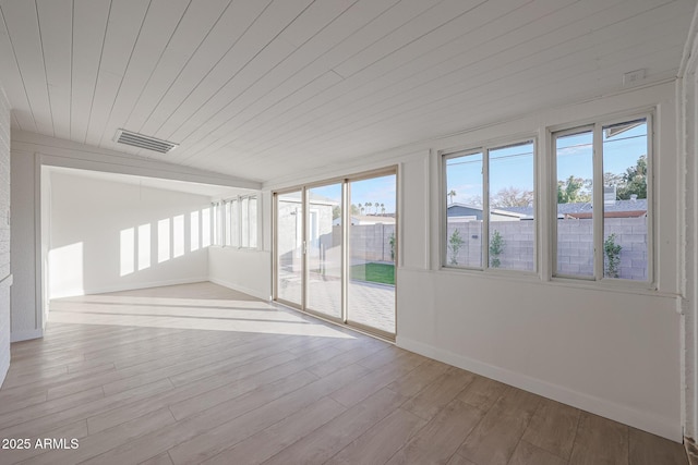 unfurnished sunroom featuring wood ceiling