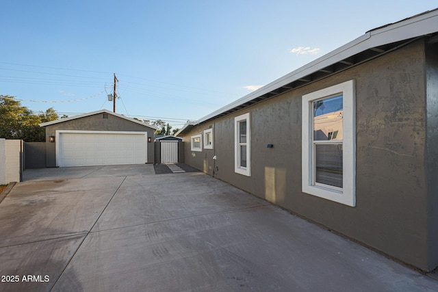 view of property exterior featuring an outdoor structure and a garage