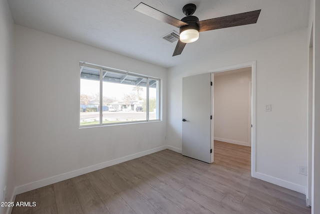 empty room featuring ceiling fan and light hardwood / wood-style floors