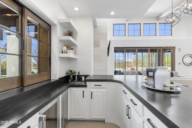 interior space featuring recessed lighting, pendant lighting, a notable chandelier, and a sink