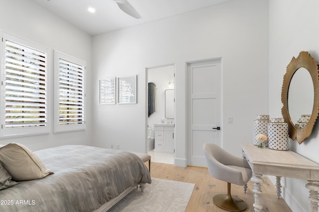 bedroom with recessed lighting, light wood finished floors, and ensuite bathroom