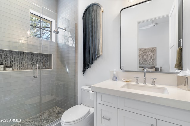 full bath with toilet, a shower stall, and vanity