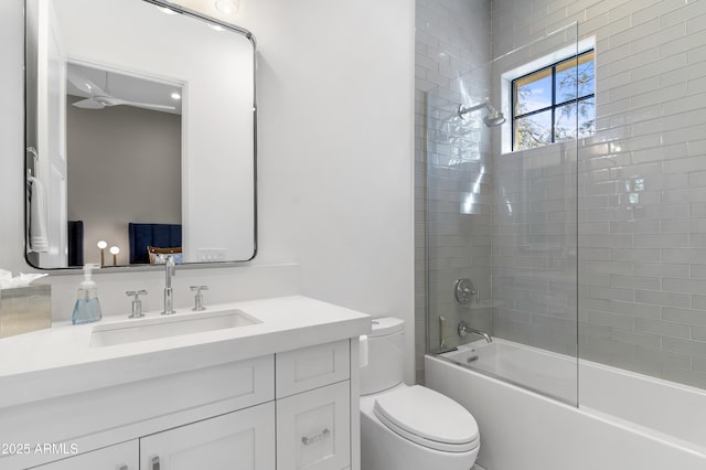 bathroom with toilet, vanity, and shower / tub combination