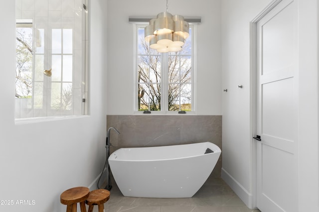 full bath with a freestanding bath and a wealth of natural light