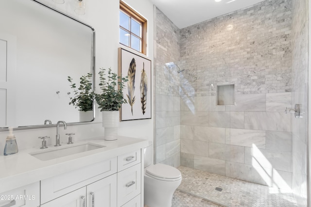 bathroom featuring a stall shower, vanity, and toilet