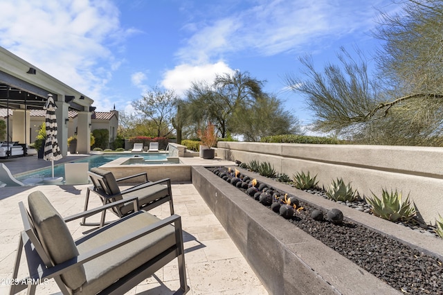 view of patio with a hot tub and a fenced in pool