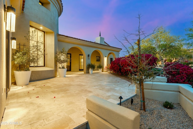 view of patio terrace at dusk