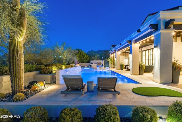 outdoor pool with a patio area