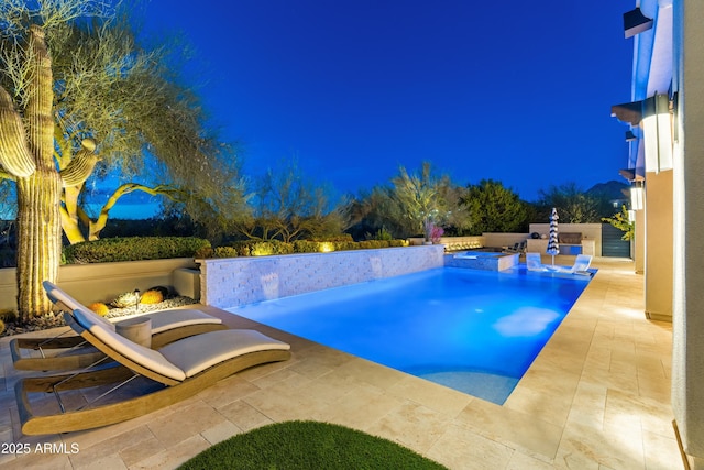 view of pool featuring a patio and an in ground hot tub