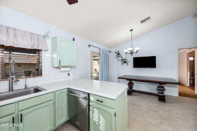 kitchen featuring lofted ceiling, sink, hanging light fixtures, dishwasher, and kitchen peninsula