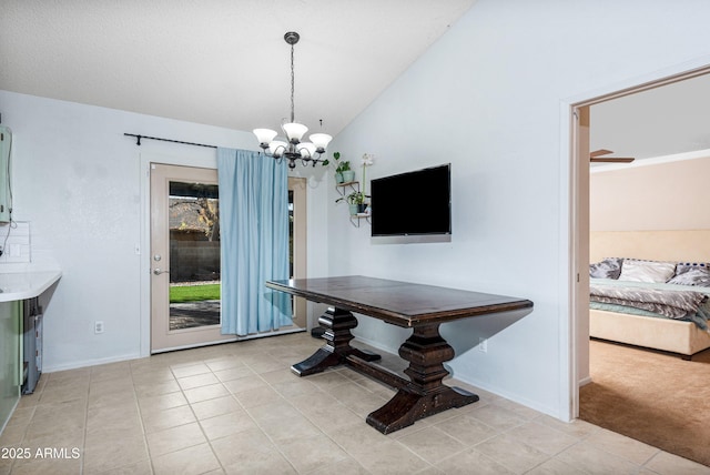 dining room with a chandelier, vaulted ceiling, and light tile patterned floors