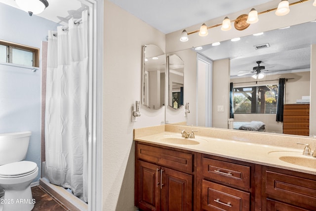 bathroom featuring ceiling fan, vanity, toilet, and a shower with shower curtain