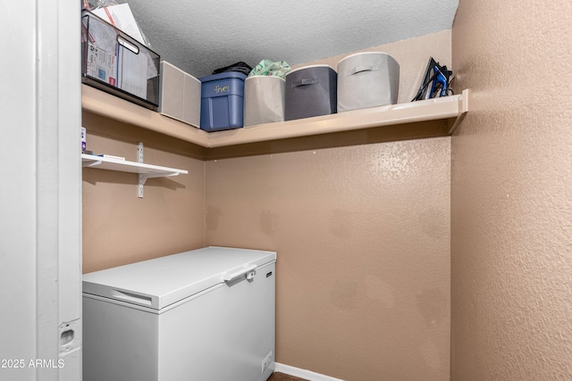 laundry area with a textured ceiling