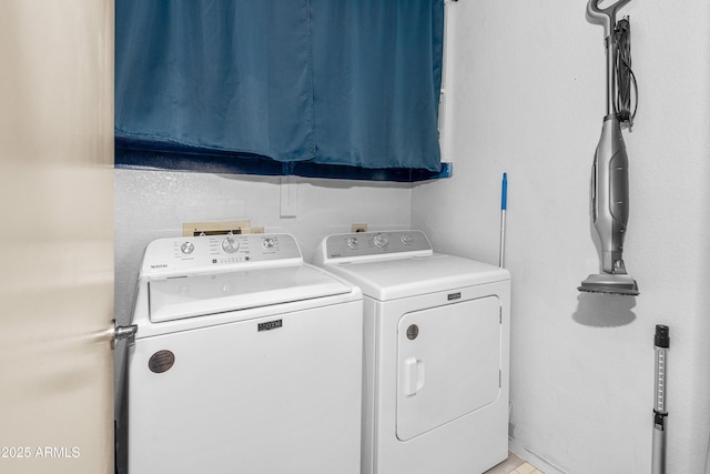 clothes washing area featuring washer and clothes dryer