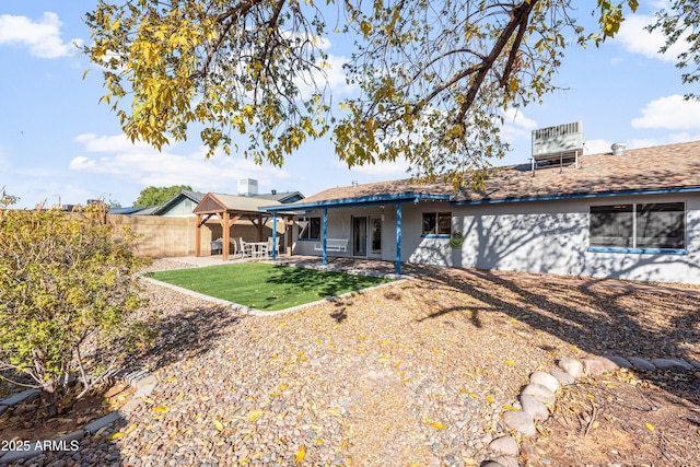 rear view of house with a patio area and a lawn