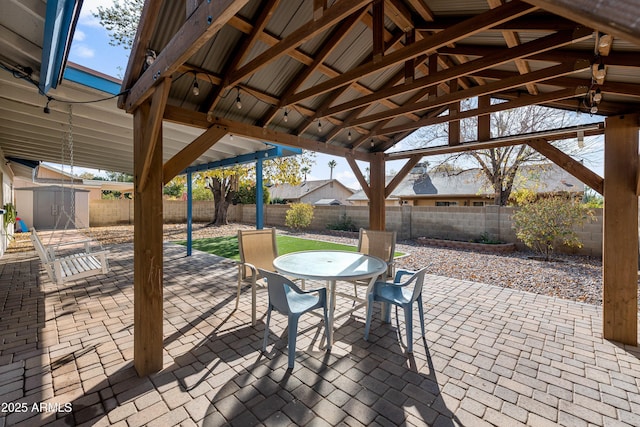 view of patio featuring a shed and a gazebo