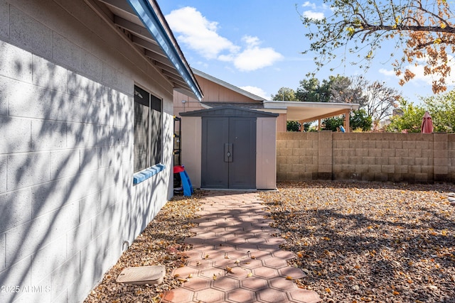 view of side of home featuring a storage shed