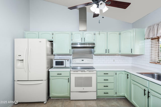 kitchen featuring white appliances, ceiling fan, green cabinets, decorative backsplash, and vaulted ceiling