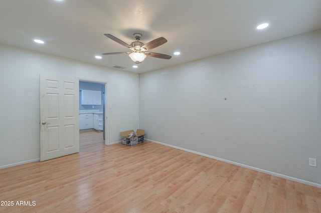 spare room featuring ceiling fan and light wood-type flooring