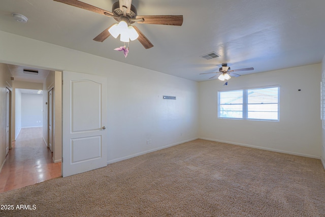 carpeted empty room featuring ceiling fan