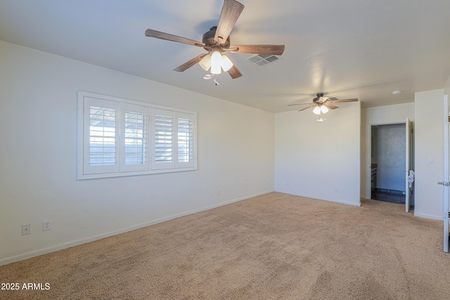 carpeted spare room featuring ceiling fan