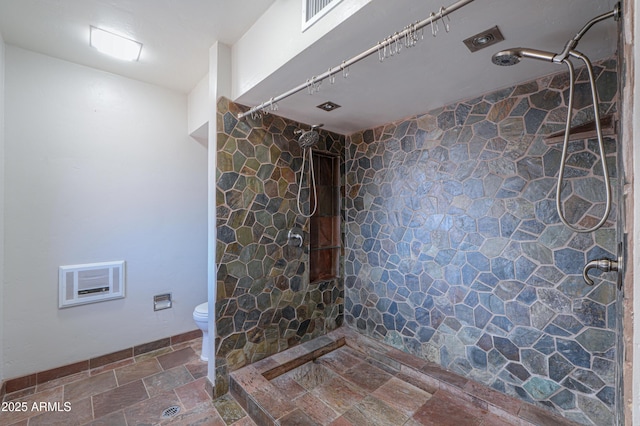 bathroom with a shower and toilet