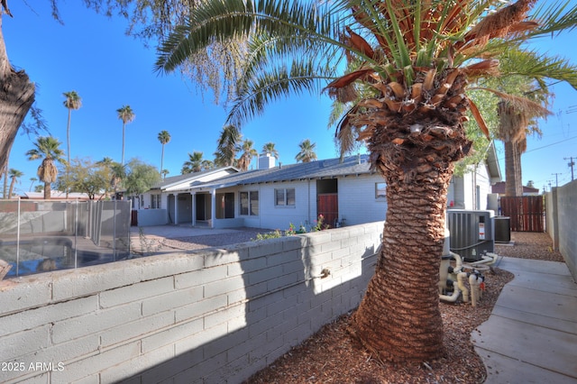 view of front facade featuring central AC and a patio area