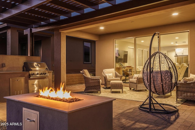 view of patio featuring exterior kitchen, a grill, a fire pit, and a pergola