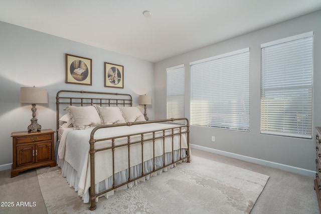 bedroom with light carpet and baseboards