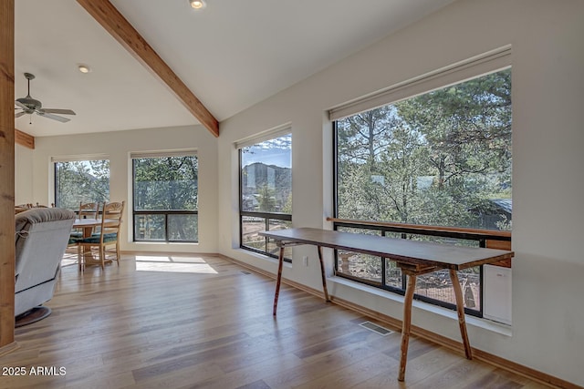 sunroom with vaulted ceiling with beams, visible vents, and a ceiling fan