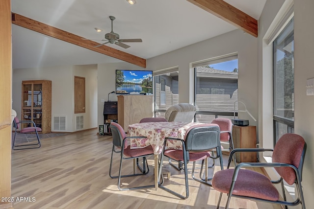 dining space featuring beam ceiling, visible vents, and wood finished floors