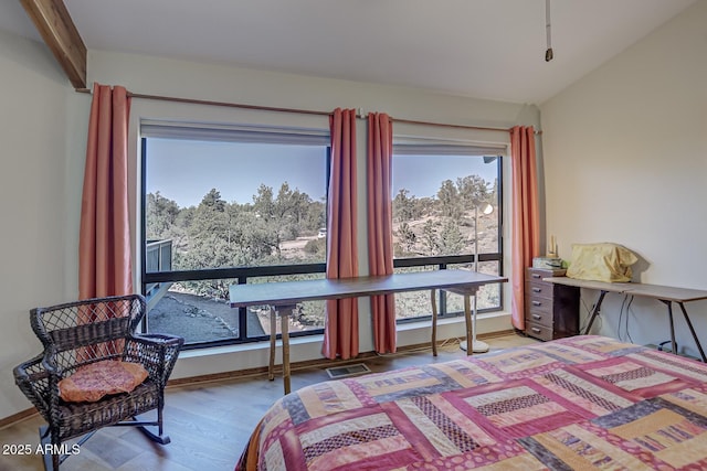 bedroom featuring baseboards, visible vents, and wood finished floors