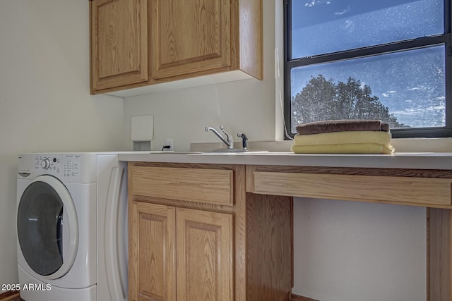 laundry room featuring washer / dryer, a healthy amount of sunlight, cabinet space, and a sink