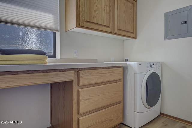 washroom with baseboards, light wood-type flooring, cabinet space, electric panel, and washer / dryer