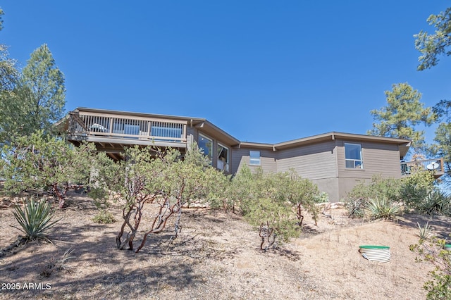 rear view of property with a wooden deck